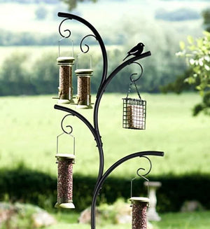Close up of bird feeder stand with multiple bird feeders in a garden setting