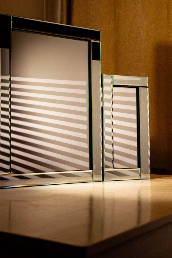 Tri fold mirror arranged in a modern bedroom