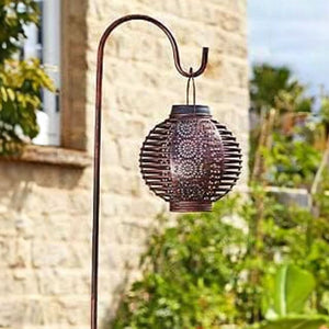 Solar hanging lights illuminating an outdoor seating area