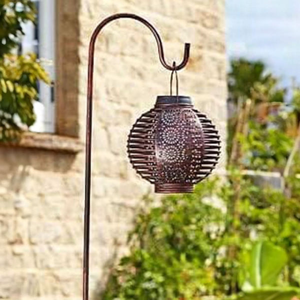 Solar hanging lights illuminating an outdoor seating area