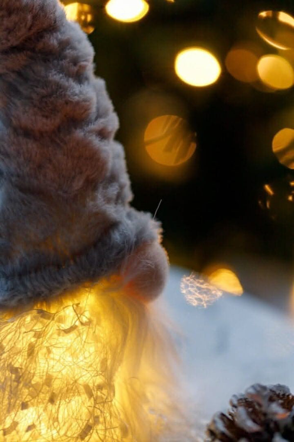 Close-up of a textured fabric surface with blurred lights in the background