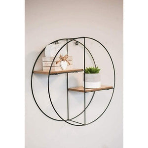 Round black metal shelf mounted on a living room wall