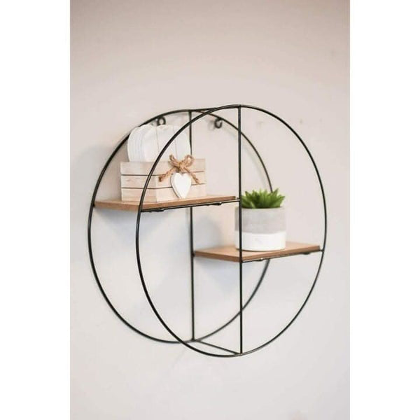 Round black metal shelf mounted on a living room wall