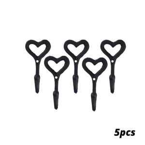 Set of five black heart-shaped plant hooks on a white background