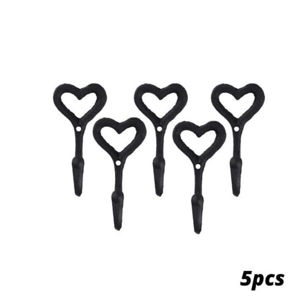 Set of five black heart-shaped plant hooks on a white background
