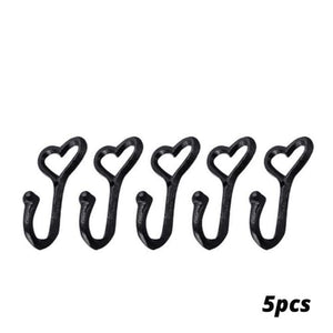 Set of five black heart-shaped hooks on a white background