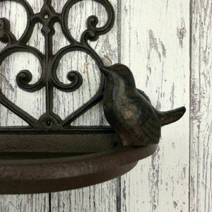 Decorative cast iron bird feeder outdoors