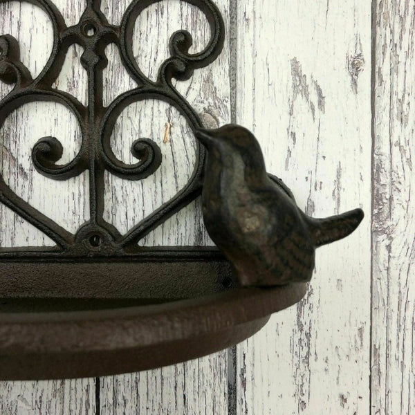 Decorative cast iron bird feeder outdoors