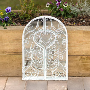 White distressed mirror displayed in a vintage room