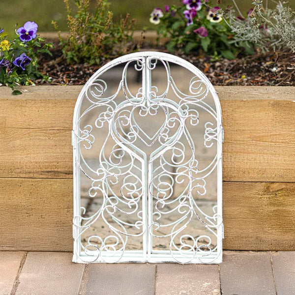 White distressed mirror displayed in a vintage room