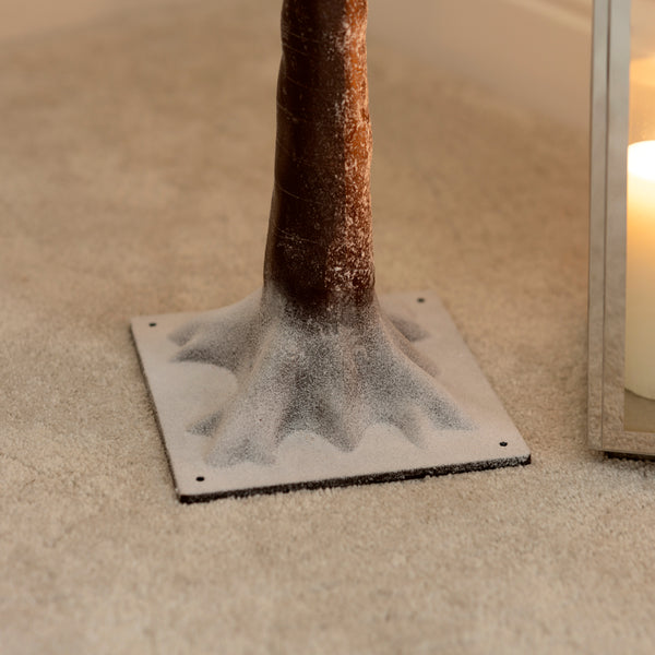 Snow-dusted branch tree with warm white LEDs