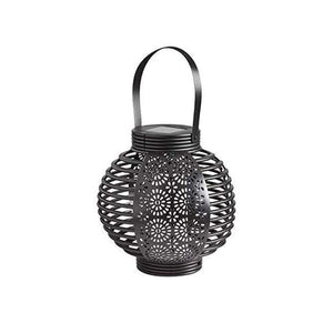 Patterned outdoor lantern displayed on garden table