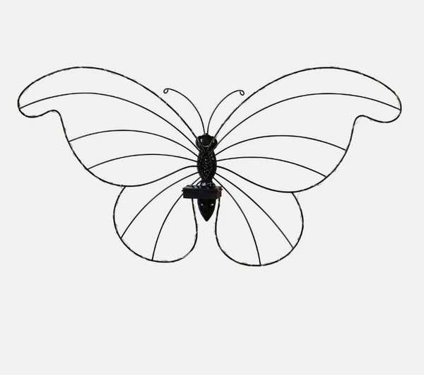Solar butterfly light displayed among garden plants