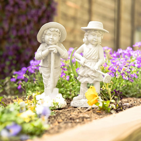 Boy and girl garden figures shown together