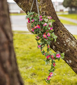Artificial pink flowers and foliage in hanging basket