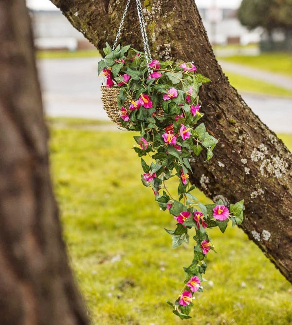Artificial pink flowers and foliage in hanging basket