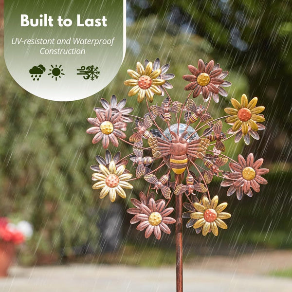 Garden windmill with rotating metal blades.
