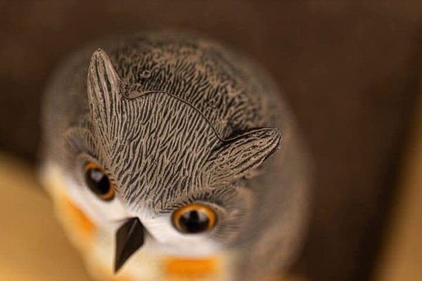Close-up of a plastic owl with a blurred background