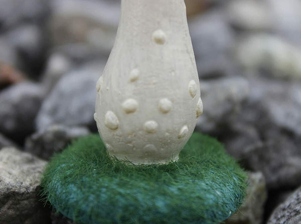 Small mushroom ornaments displayed in garden pot