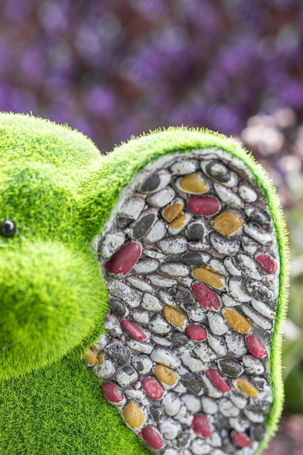 Decorative elephant with artificial grass body