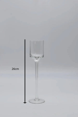 Three glass candle holders arranged as centrepiece