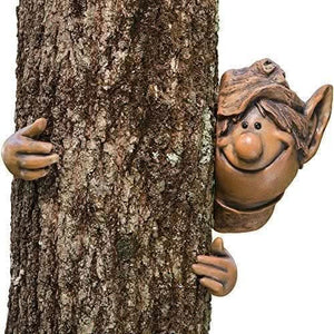 Garden elf figure peeking around tree