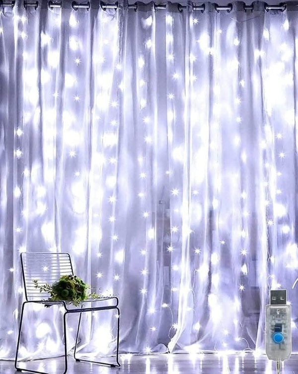 White curtain fairy lights displayed across a window