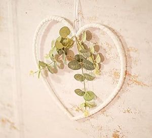 Botanical heart wreath displayed against a door