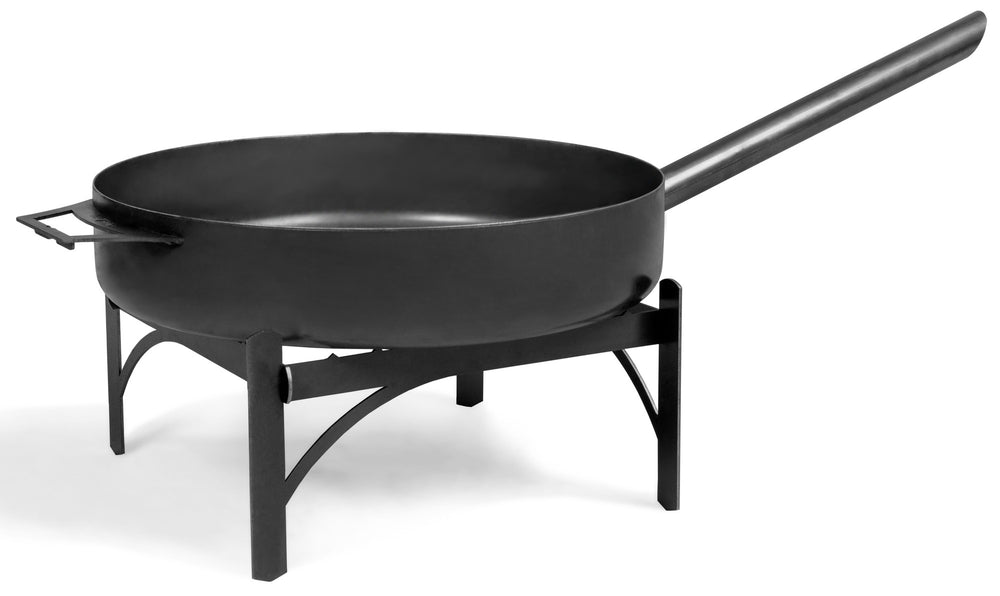 A large black steel pan with a long handle, suitable for outdoor cooking on a fire bowl.