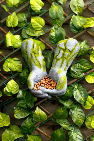 Outdoor bird feeder hands sculpture