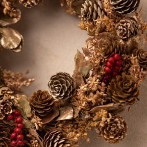 Red berry fragrance wreath displayed with Christmas decor