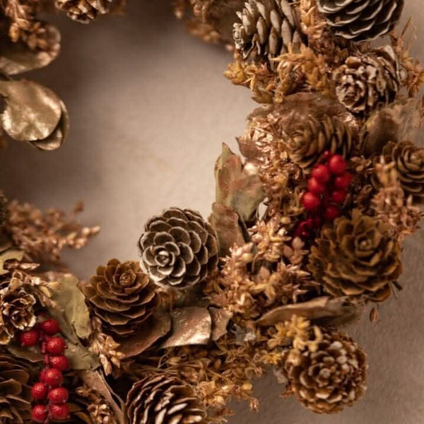 Red berry fragrance wreath displayed with Christmas decor