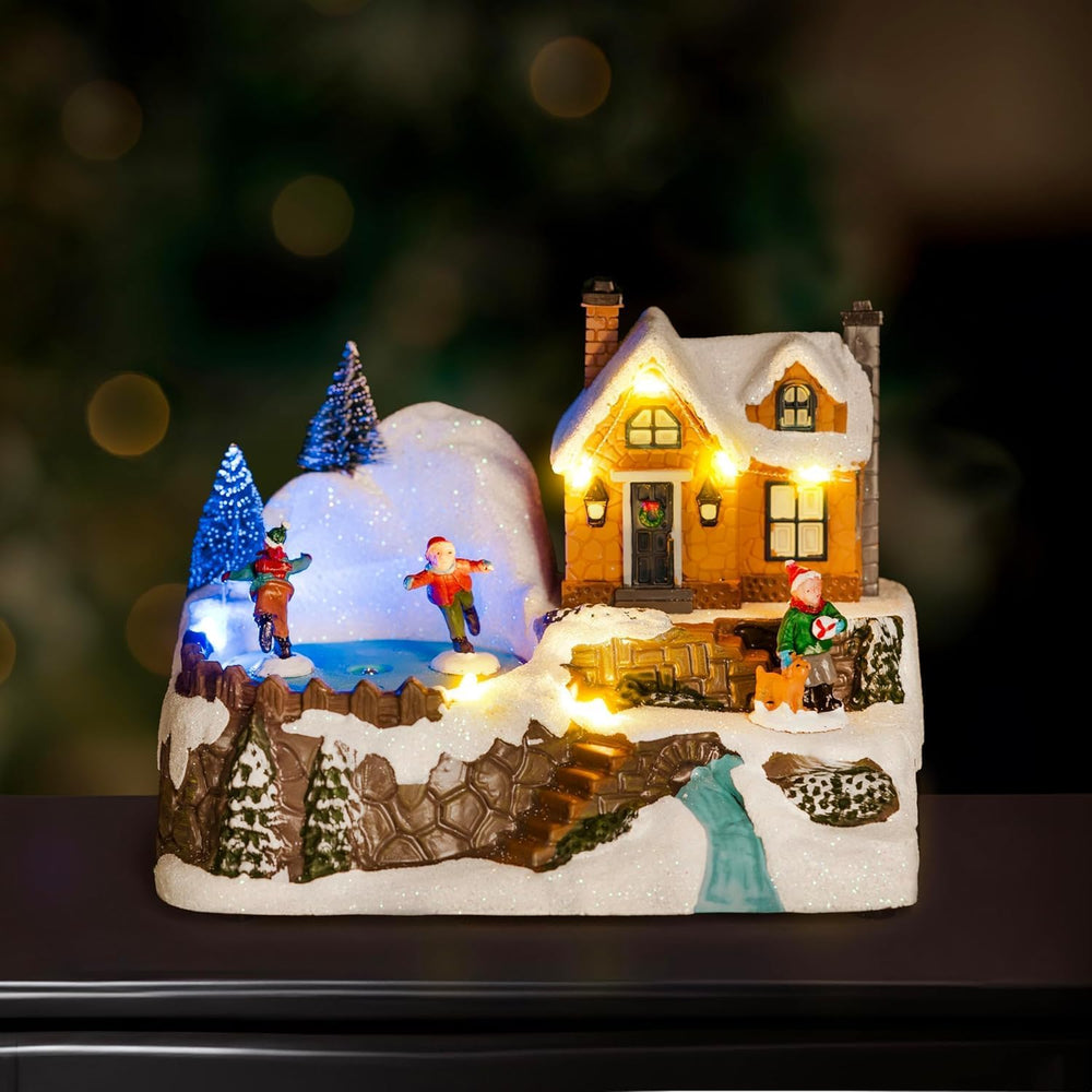 Winter village scene with central ice rink Christmas decoration