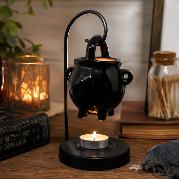 Hanging black oil burner styled with Halloween decorations