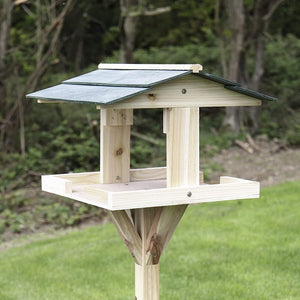 Wooden garden feeding station designed for small birds
