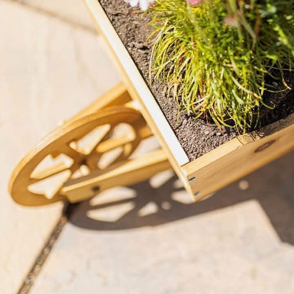 Rustic wooden wheelbarrow planter displayed outdoors