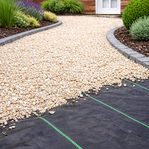 Weed control fabric installed beneath a pathway