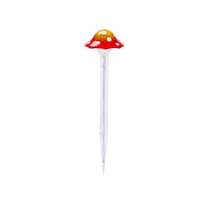 Yellow toadstool solar light positioned in a garden flower bed